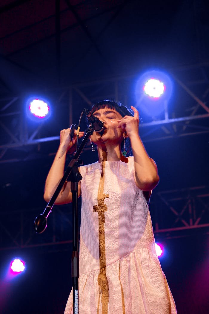 A female singer captivates the audience during a live concert in Indonesia.